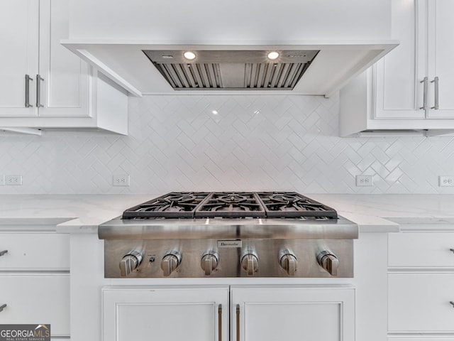 kitchen with stainless steel gas cooktop, white cabinetry, and decorative backsplash