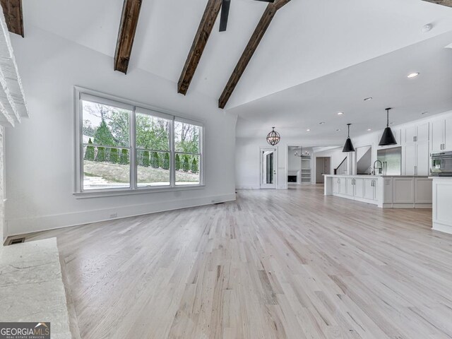 2535 Lake View Ct, Milton, GA 30004 - unfurnished living room with light wood-style floors, baseboards, a sink, high vaulted ceiling, and recessed lighting