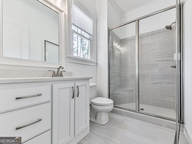 bathroom with toilet, a stall shower, and vanity