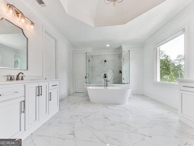 bathroom featuring a shower stall, vanity, a freestanding bath, marble finish floors, and crown molding