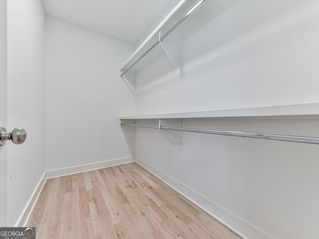 spacious closet with wood finished floors
