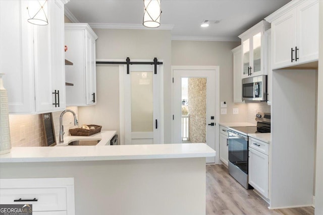 323 S Madison Ave, Monroe, GA 30655 - kitchen with stainless steel appliances, a sink, tasteful backsplash, white cabinets, and crown molding