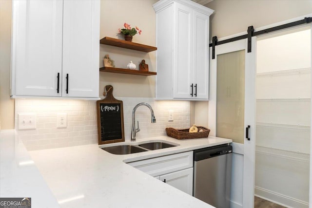 323 S Madison Ave, Monroe, GA 30655 - kitchen featuring a sink, stainless steel dishwasher, light countertops, white cabinets, and tasteful backsplash