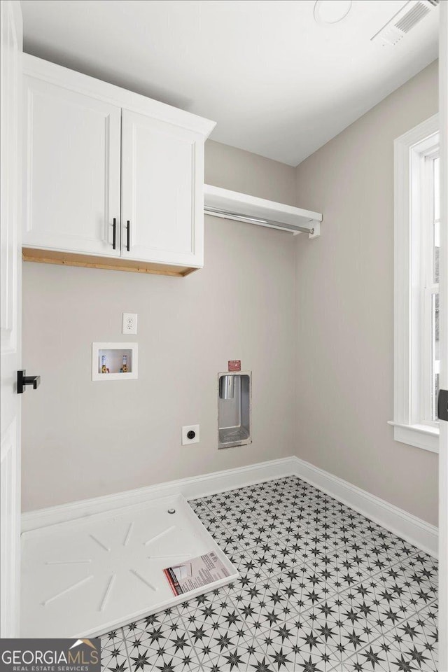 323 S Madison Ave, Monroe, GA 30655 - washroom with cabinet space, electric dryer hookup, washer hookup, tile patterned floors, and baseboards
