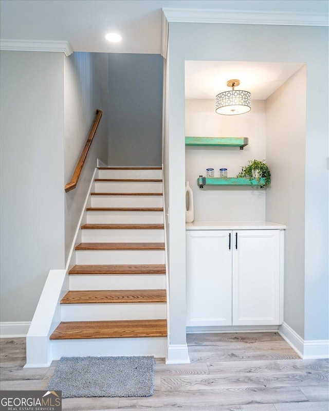 323 S Madison Ave, Monroe, GA 30655 - staircase with crown molding, wood finished floors, baseboards, and recessed lighting