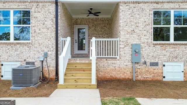 323 S Madison Ave, Monroe, GA 30655 - view of exterior entry with central AC, a ceiling fan, and brick siding