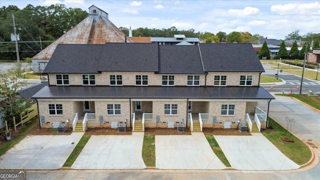 323 S Madison Ave, Monroe, GA 30655 - rear view of house featuring metal roof and central AC