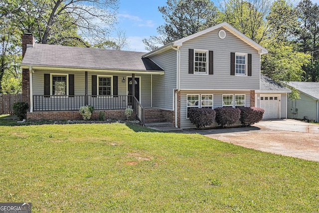 split level home featuring a chimney, driveway, an attached garage, a porch, and a front yard