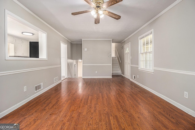 spare room featuring baseboards, a ceiling fan, visible vents, and ornamental molding