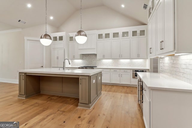 117 Wildwood Dr, Eatonton, GA 31024 - kitchen featuring a sink, light countertops, backsplash, white cabinetry, and visible vents