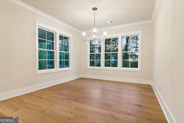 117 Wildwood Dr, Eatonton, GA 31024 - unfurnished dining area featuring visible vents, baseboards, wood finished floors, and ornamental molding