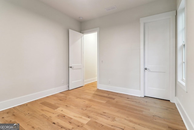 117 Wildwood Dr, Eatonton, GA 31024 - unfurnished bedroom with baseboards, light wood-style flooring, and visible vents