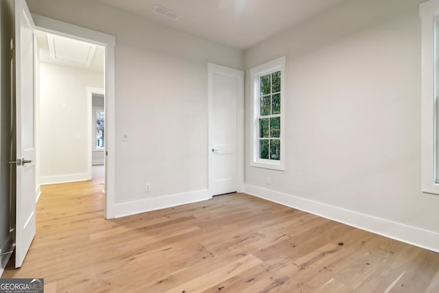 117 Wildwood Dr, Eatonton, GA 31024 - empty room with light wood finished floors, attic access, baseboards, and visible vents