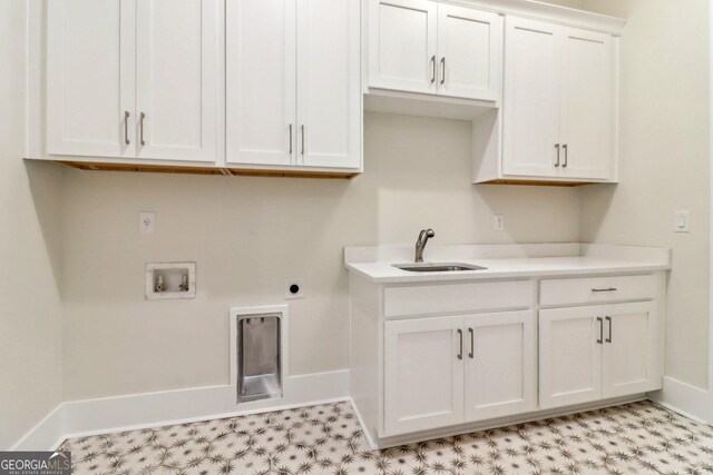 117 Wildwood Dr, Eatonton, GA 31024 - laundry room with cabinet space, hookup for a washing machine, baseboards, and a sink