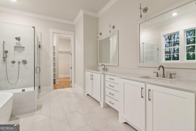 117 Wildwood Dr, Eatonton, GA 31024 - bathroom featuring crown molding, a freestanding tub, a sink, and a stall shower