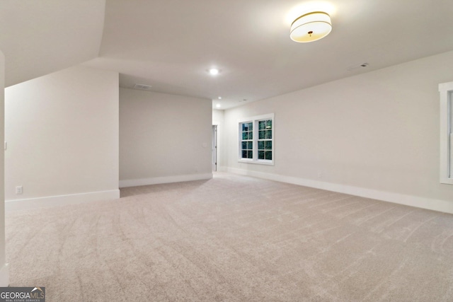 117 Wildwood Dr, Eatonton, GA 31024 - unfurnished room featuring recessed lighting, lofted ceiling, visible vents, carpet floors, and baseboards