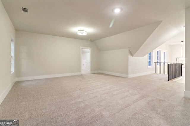 117 Wildwood Dr, Eatonton, GA 31024 - additional living space featuring baseboards, carpet flooring, and vaulted ceiling