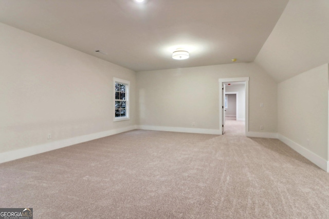 117 Wildwood Dr, Eatonton, GA 31024 - bonus room with baseboards, lofted ceiling, and light colored carpet