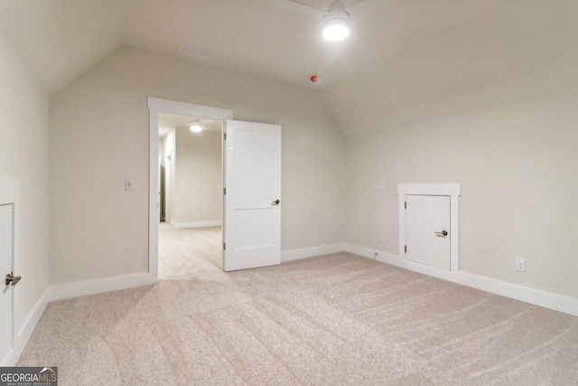 117 Wildwood Dr, Eatonton, GA 31024 - bonus room with baseboards, lofted ceiling, and light carpet