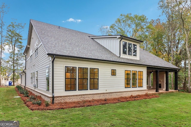 117 Wildwood Dr, Eatonton, GA 31024 - back of house with a lawn, brick siding, and roof with shingles