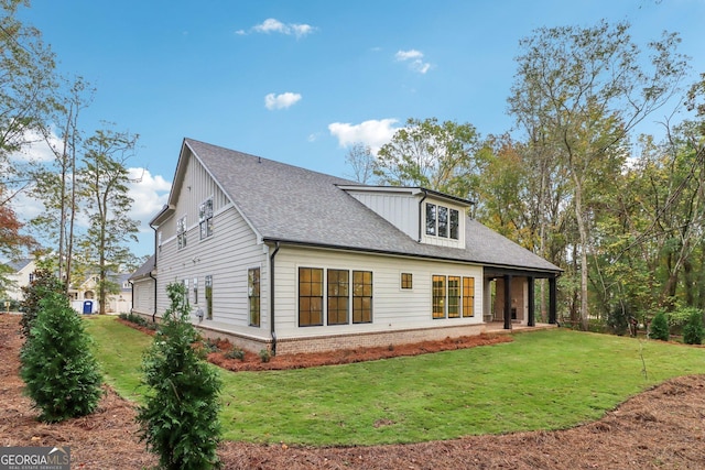 117 Wildwood Dr, Eatonton, GA 31024 - rear view of property featuring a lawn and a shingled roof
