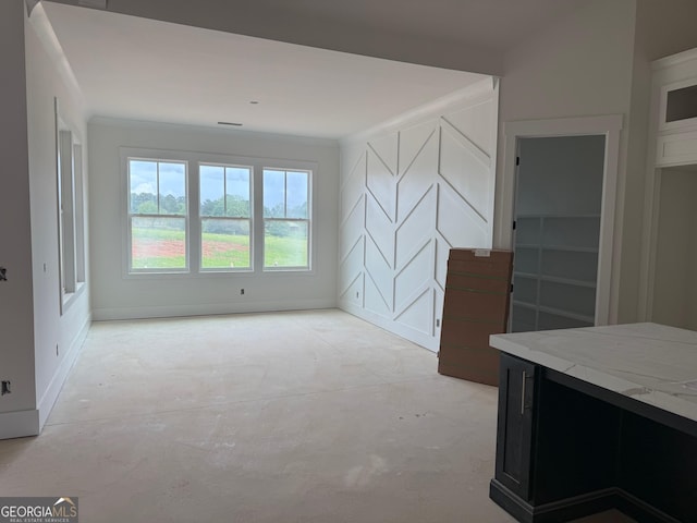 117 Wildwood Dr, Eatonton, GA 31024 - unfurnished living room with concrete flooring, crown molding, and baseboards
