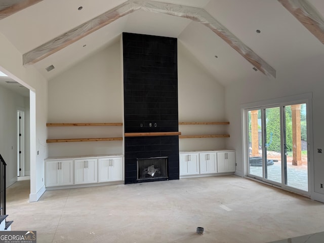 117 Wildwood Dr, Eatonton, GA 31024 - unfurnished living room featuring a large fireplace, beam ceiling, high vaulted ceiling, and visible vents