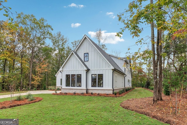 117 Wildwood Dr, Eatonton, GA 31024 - rear view of house with brick siding, driveway, board and batten siding, a yard, and roof with shingles