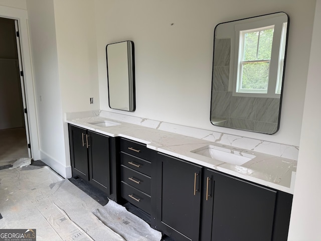 117 Wildwood Dr, Eatonton, GA 31024 - bathroom featuring baseboards, a sink, and double vanity