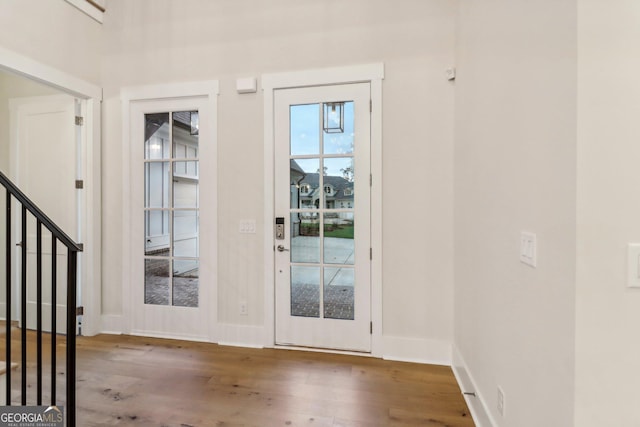 117 Wildwood Dr, Eatonton, GA 31024 - doorway with stairway, baseboards, and wood finished floors