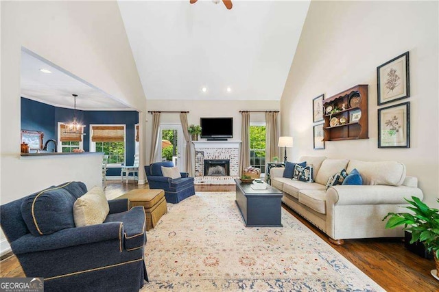 204 Overland Trl, Mcdonough, GA 30252 - living room with high vaulted ceiling, a brick fireplace, dark wood-style floors, and recessed lighting