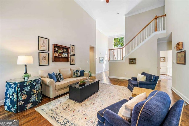 204 Overland Trl, Mcdonough, GA 30252 - living area with baseboards, wood finished floors, a towering ceiling, and stairway
