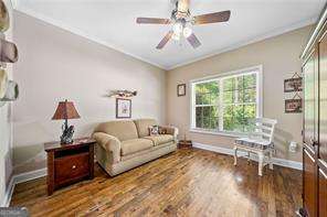204 Overland Trl, Mcdonough, GA 30252 - living room featuring wood finished floors, crown molding, baseboards, and a ceiling fan
