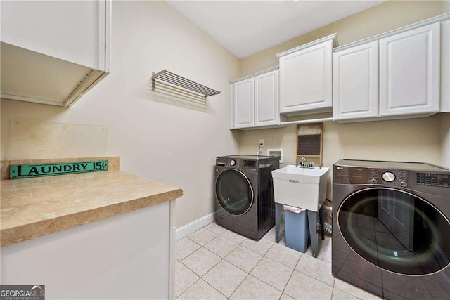 204 Overland Trl, Mcdonough, GA 30252 - laundry area with cabinet space, washing machine and dryer, baseboards, and light tile patterned flooring