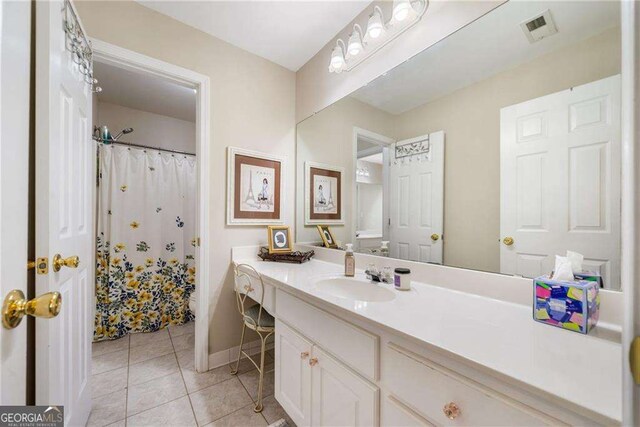 204 Overland Trl, Mcdonough, GA 30252 - bathroom with tile patterned floors, baseboards, visible vents, curtained shower, and vanity