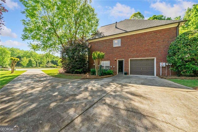 204 Overland Trl, Mcdonough, GA 30252 - view of side of property featuring brick siding, driveway, and a garage