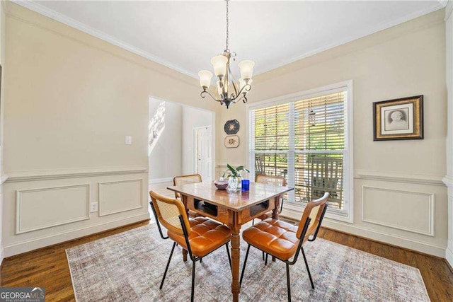 204 Overland Trl, Mcdonough, GA 30252 - dining area featuring a decorative wall, wood finished floors, wainscoting, a chandelier, and ornamental molding