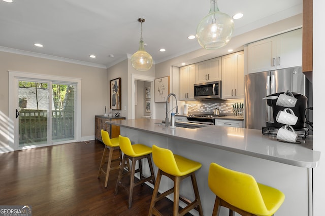 738 Saint Charles Ave NE, Atlanta, GA 30306 - kitchen featuring stainless steel appliances, a kitchen breakfast bar, a sink, decorative backsplash, and crown molding