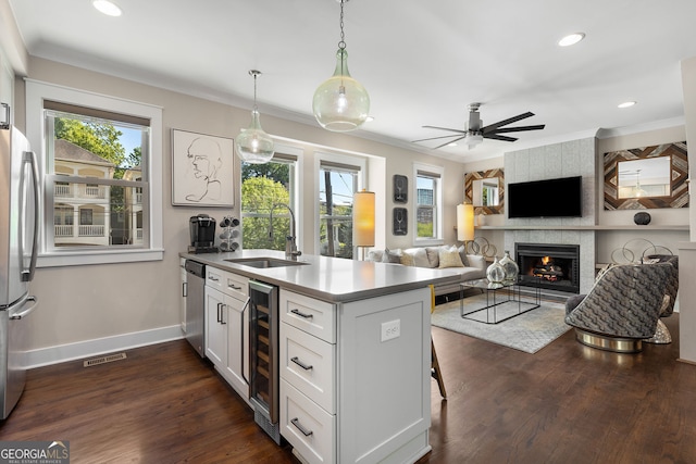 738 Saint Charles Ave NE, Atlanta, GA 30306 - kitchen with a peninsula, a sink, a healthy amount of sunlight, visible vents, and beverage cooler