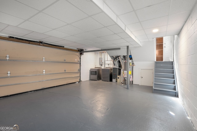 738 Saint Charles Ave NE, Atlanta, GA 30306 - garage with washing machine and clothes dryer, concrete block wall, and water heater