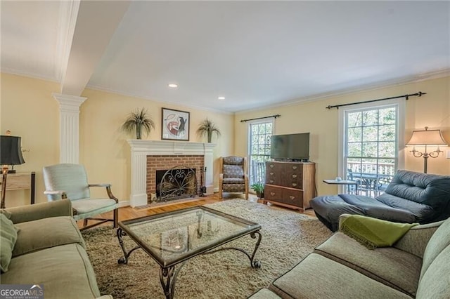 5251 Amberbrook Ct, Marietta, GA 30068 - living room with recessed lighting, ornate columns, wood finished floors, crown molding, and a fireplace