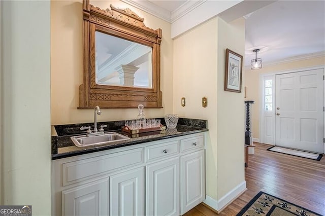 5251 Amberbrook Ct, Marietta, GA 30068 - bar featuring indoor wet bar, light wood finished floors, ornamental molding, and a sink