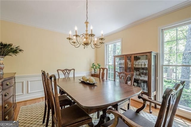 5251 Amberbrook Ct, Marietta, GA 30068 - dining room with a chandelier, light wood-type flooring, a wainscoted wall, and ornamental molding