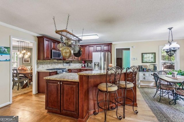 5876 Bridgemont Pl NW, Acworth, GA 30101 - kitchen with a chandelier, light wood-style floors, and appliances with stainless steel finishes