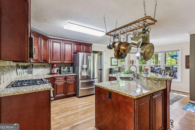 5876 Bridgemont Pl NW, Acworth, GA 30101 - kitchen featuring a sink, light wood-type flooring, reddish brown cabinets, crown molding, and appliances with stainless steel finishes