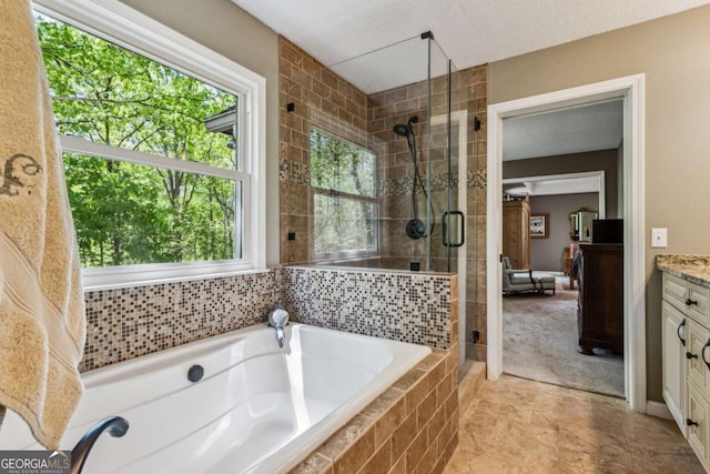 5876 Bridgemont Pl NW, Acworth, GA 30101 - bathroom with a bath, a shower stall, and vanity