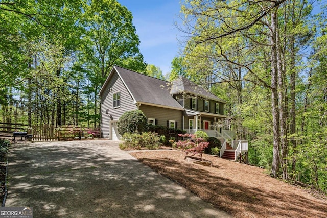 5876 Bridgemont Pl NW, Acworth, GA 30101 - view of property exterior with a garage, aphalt driveway, and fence