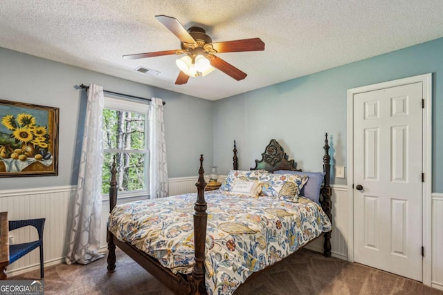 5876 Bridgemont Pl NW, Acworth, GA 30101 - carpeted bedroom with a textured ceiling, visible vents, a wainscoted wall, and ceiling fan
