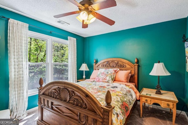 5876 Bridgemont Pl NW, Acworth, GA 30101 - carpeted bedroom with a textured ceiling, a ceiling fan, baseboards, and visible vents