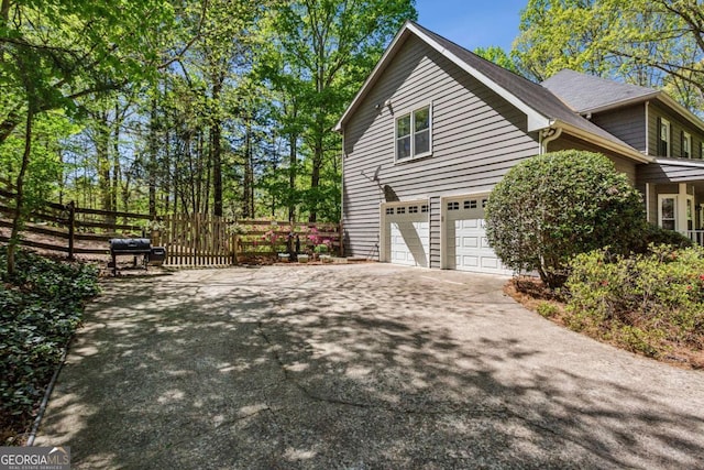 5876 Bridgemont Pl NW, Acworth, GA 30101 - view of side of property with a garage, driveway, and fence